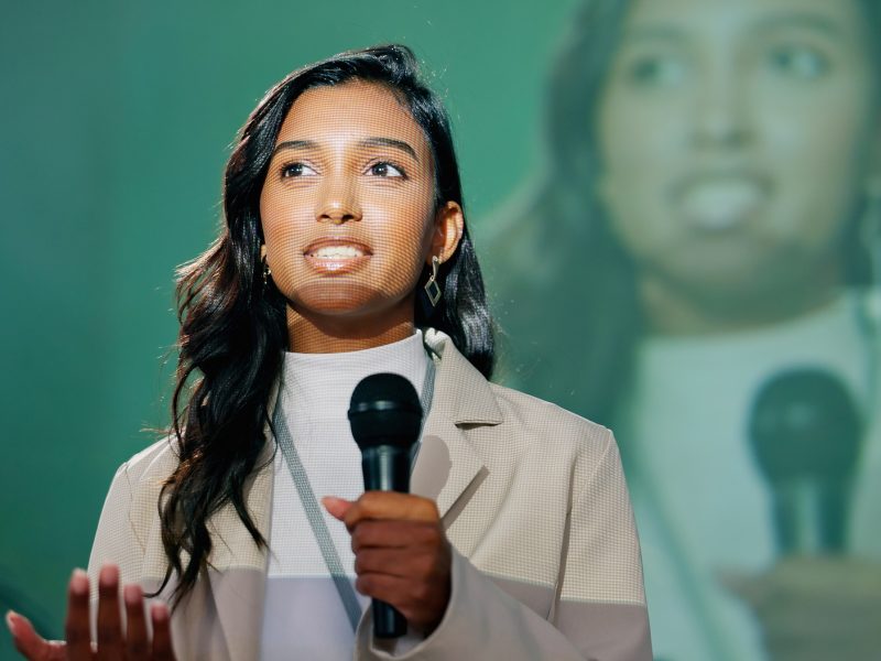 Conference, presentation or seminar and public speaking woman with microphone on stage for developm