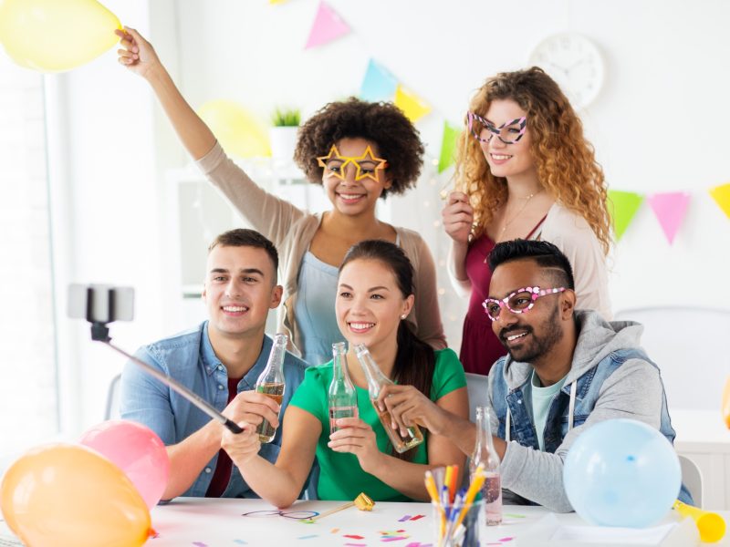 happy team taking selfie at office party