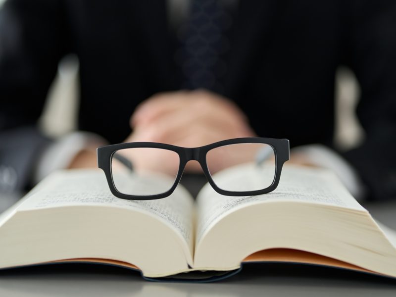 Image of intellectual labor with glasses and dictionaries